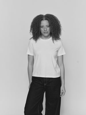 Model standing in black jeans wearing the Saint Sirène Best Friend Tee in white.