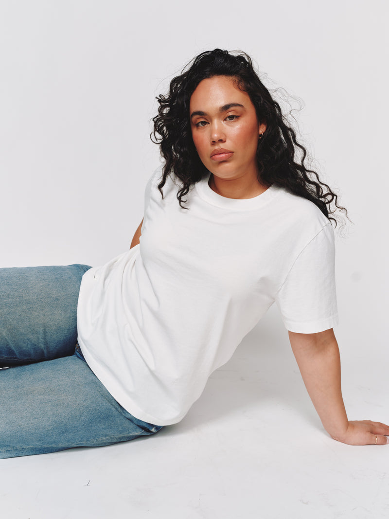 Model wearing The Boyfriend Tee in vintage white by Saint Sirène.