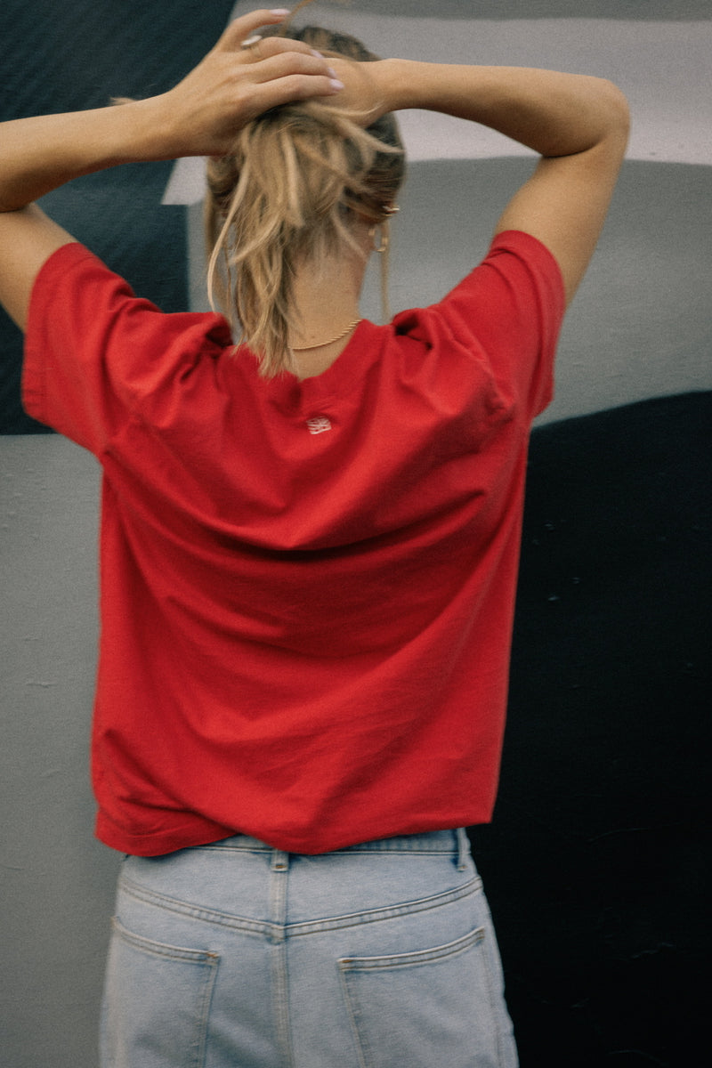 Model wearing the Saint Sirène Red Boyfriend Tee from the back, featuring a relaxed tailored fit in a limited-edition cherry red color.